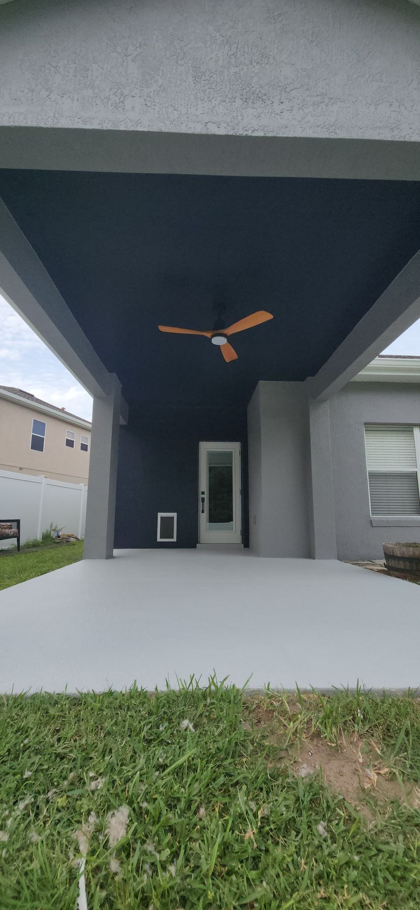A house with a covered patio in the backyard.