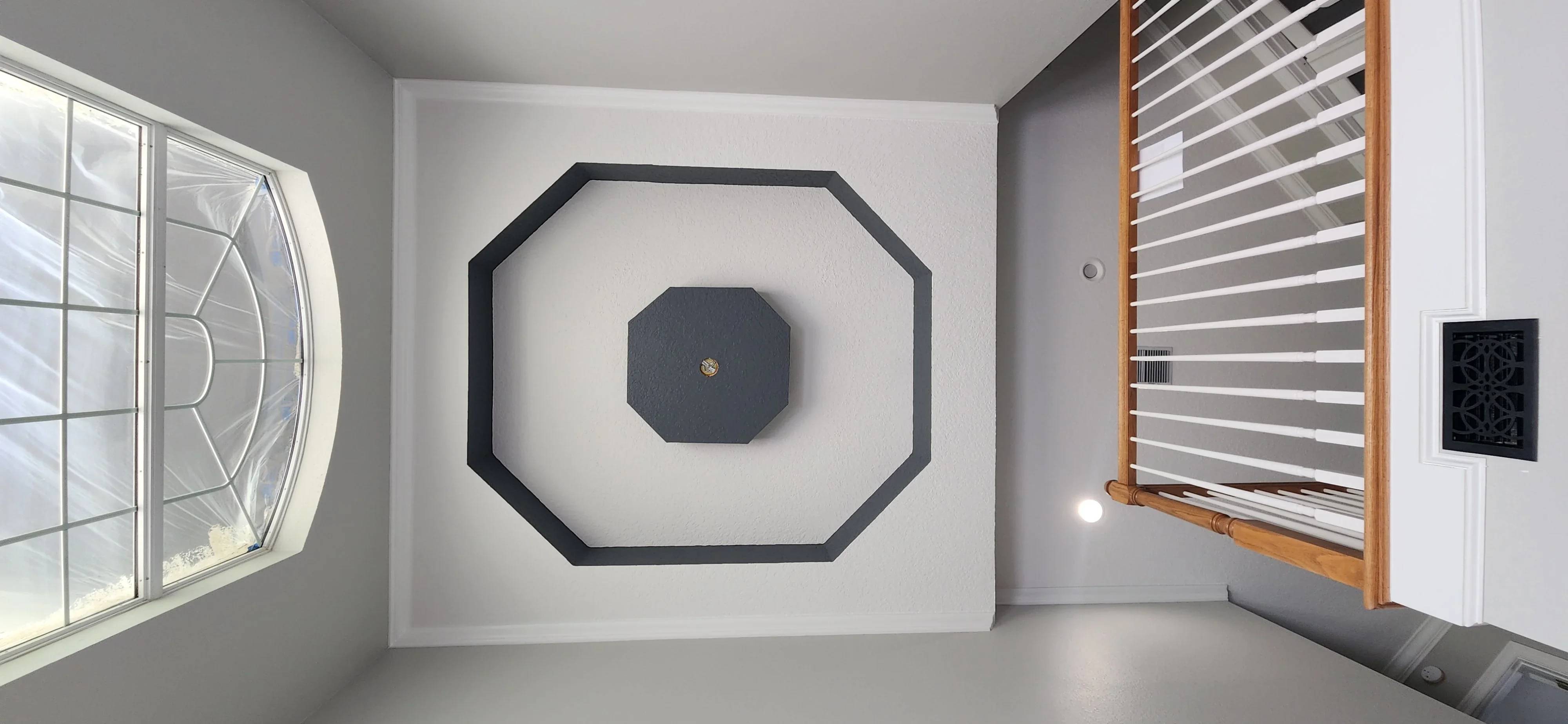 White painted drywall with black octagonal geometric frame accent wall design