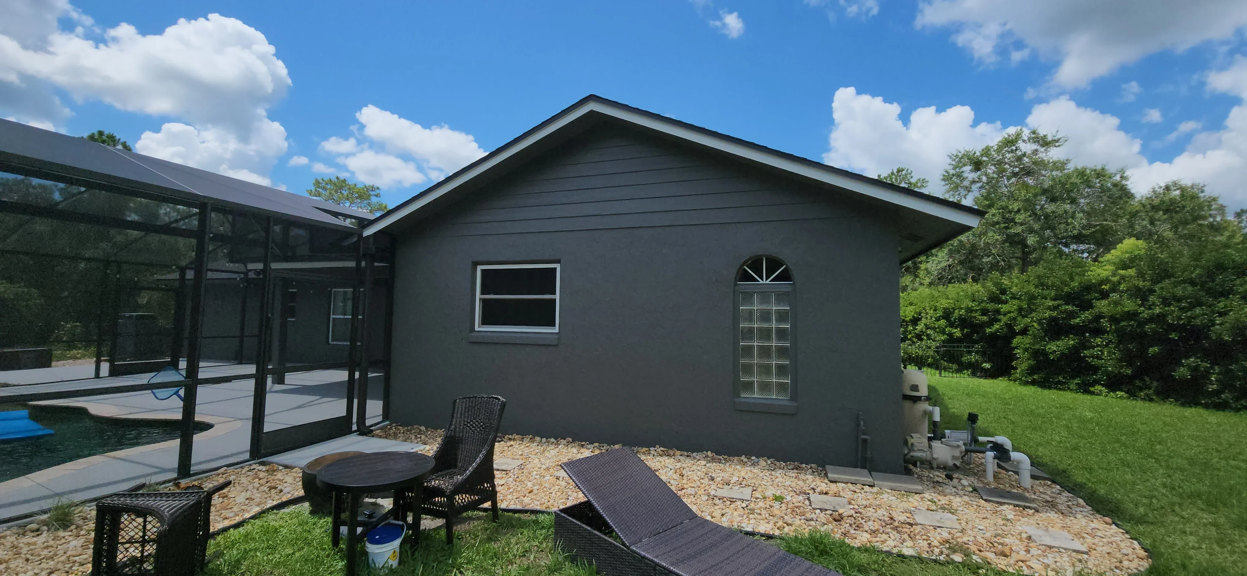 Dark charcoal painted residential home exterior with white trim windows and gable roof