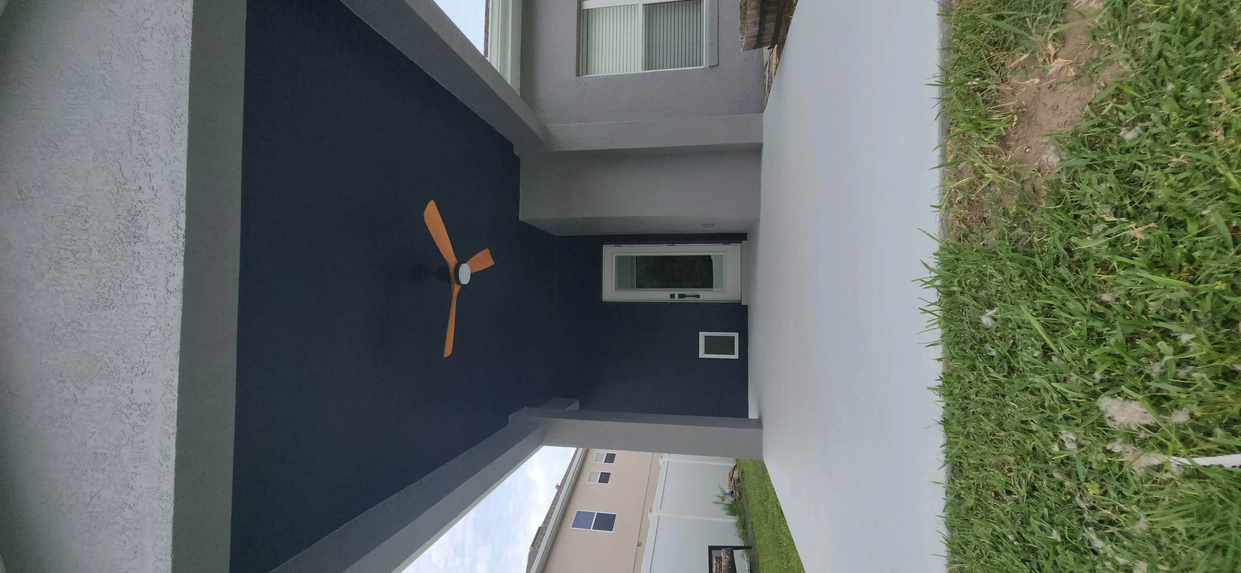 Navy blue painted garage interior wall with orange propeller wall art and white trim