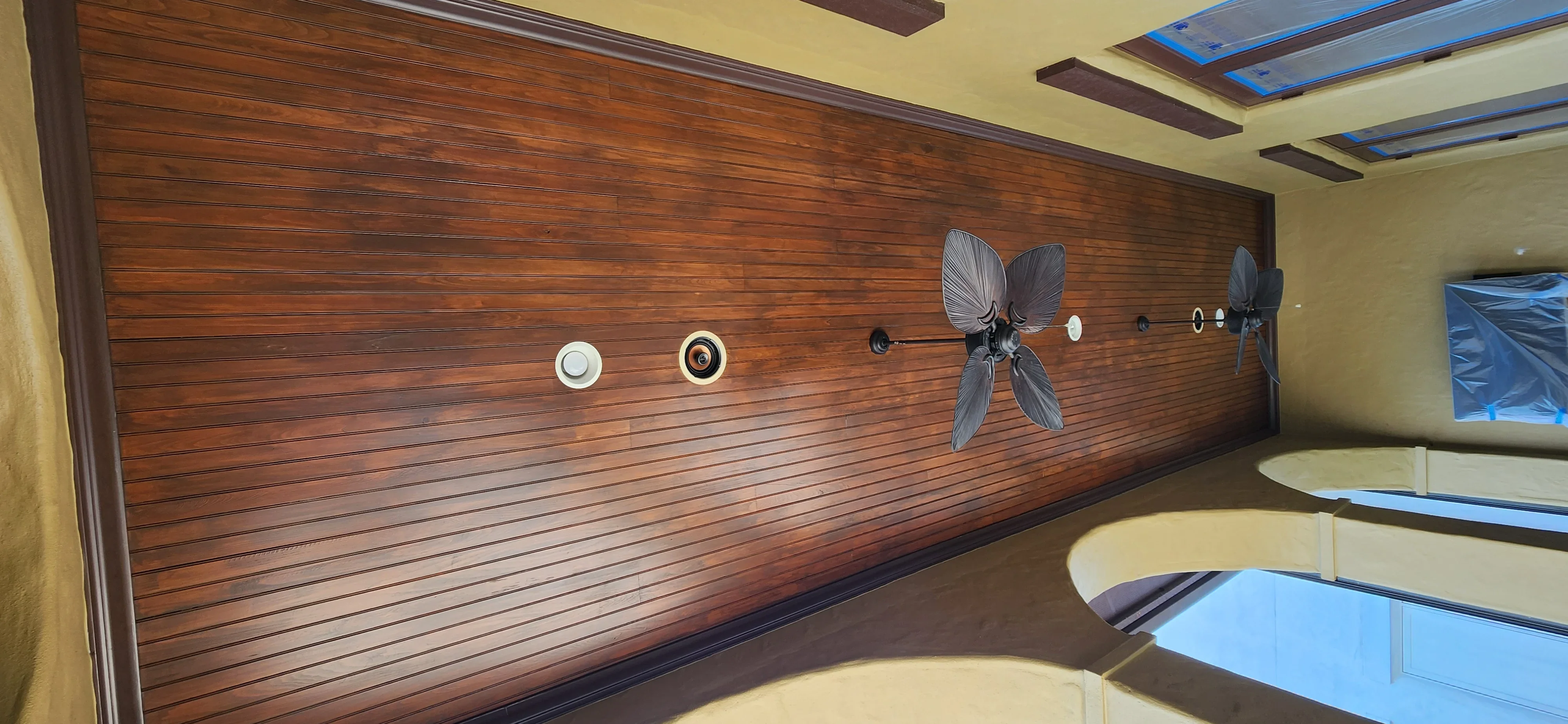 Horizontal shiplap wood accent wall with stained finish, decorative hardware, and trim work