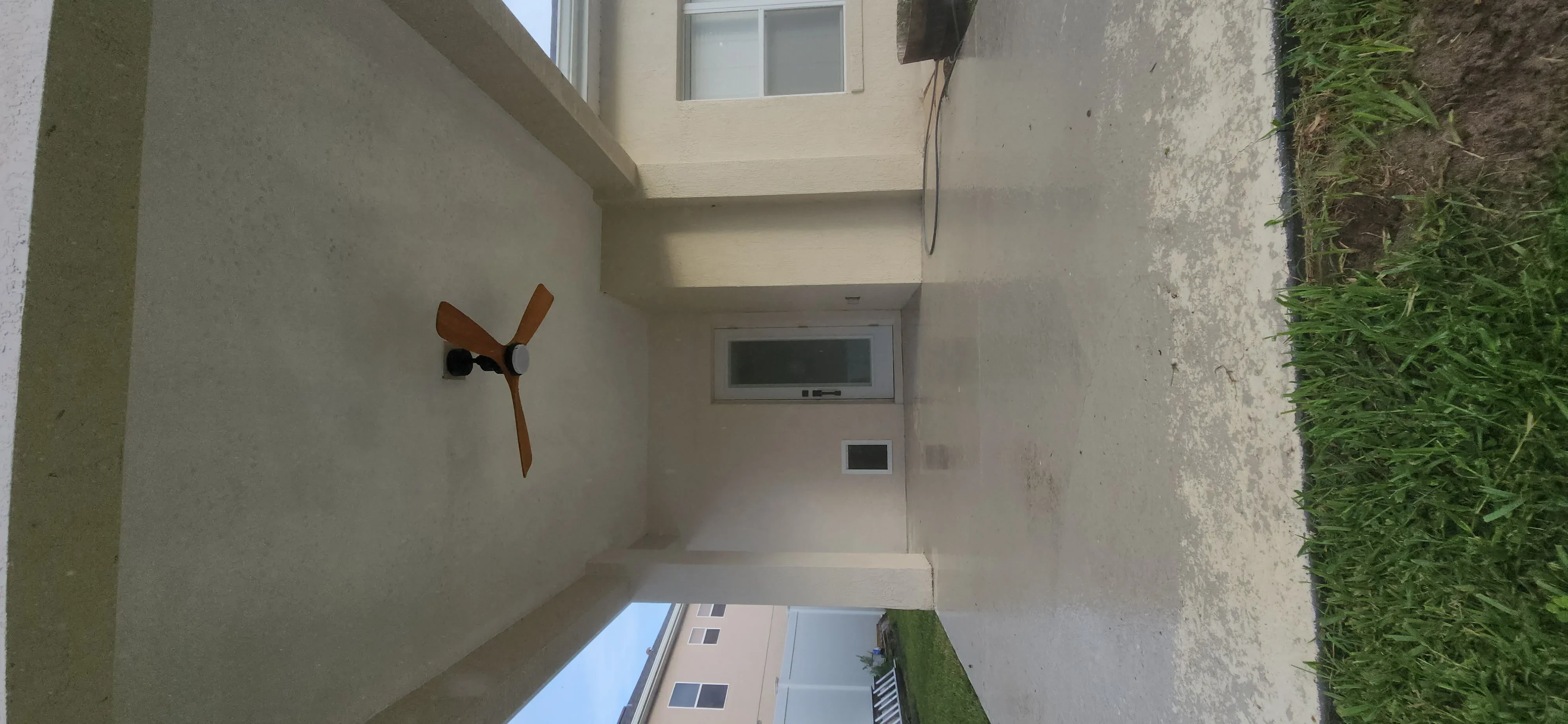 Freshly painted interior corridor with white drywall walls, window, and door frame