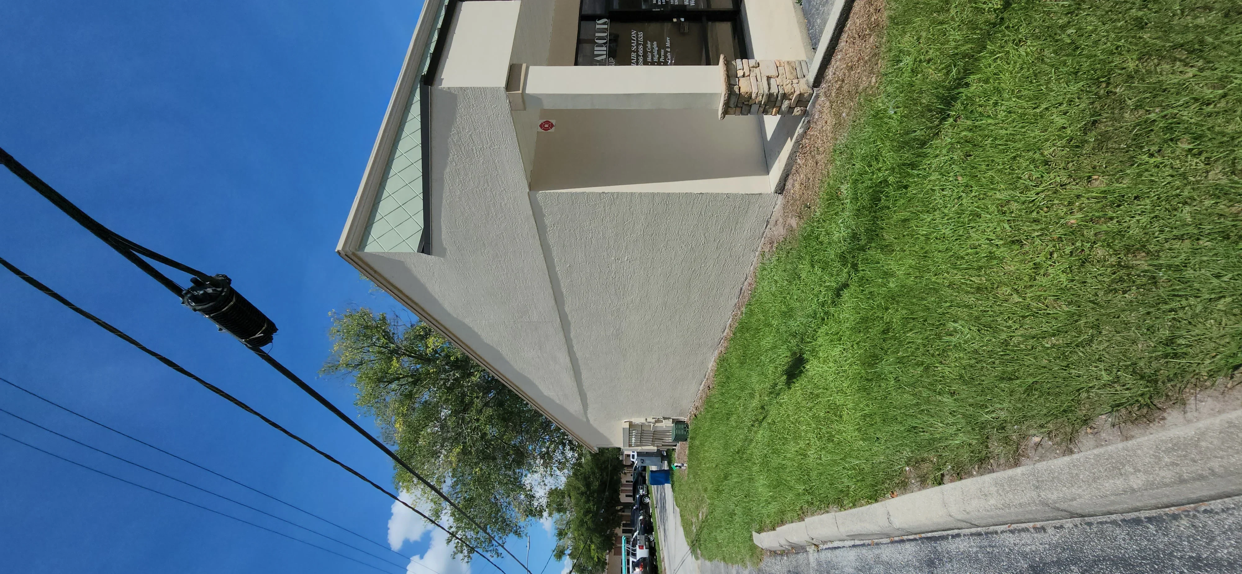 Freshly painted white stucco exterior wall with textured finish and clean trim details