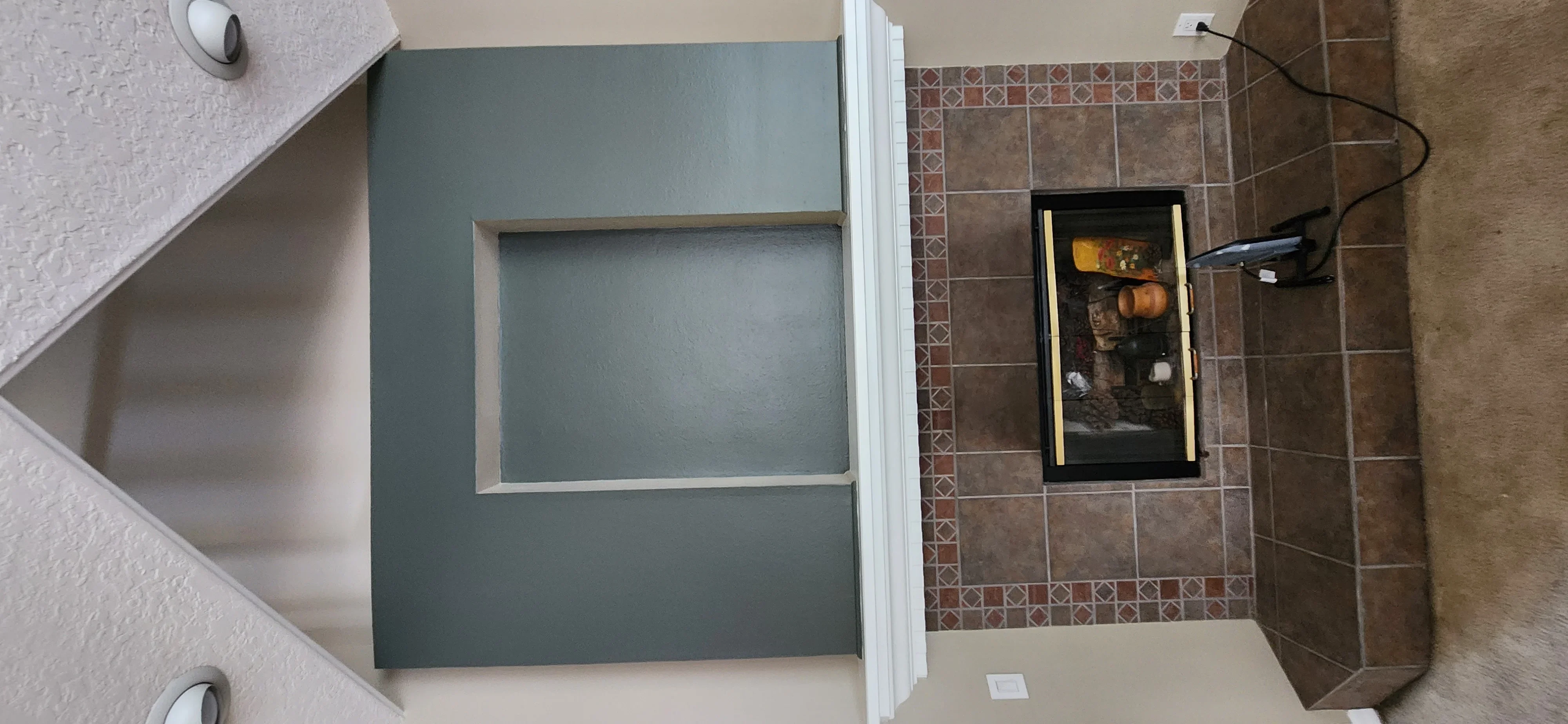 Teal-painted drywall with white trim in bathroom, brown tile backsplash visible