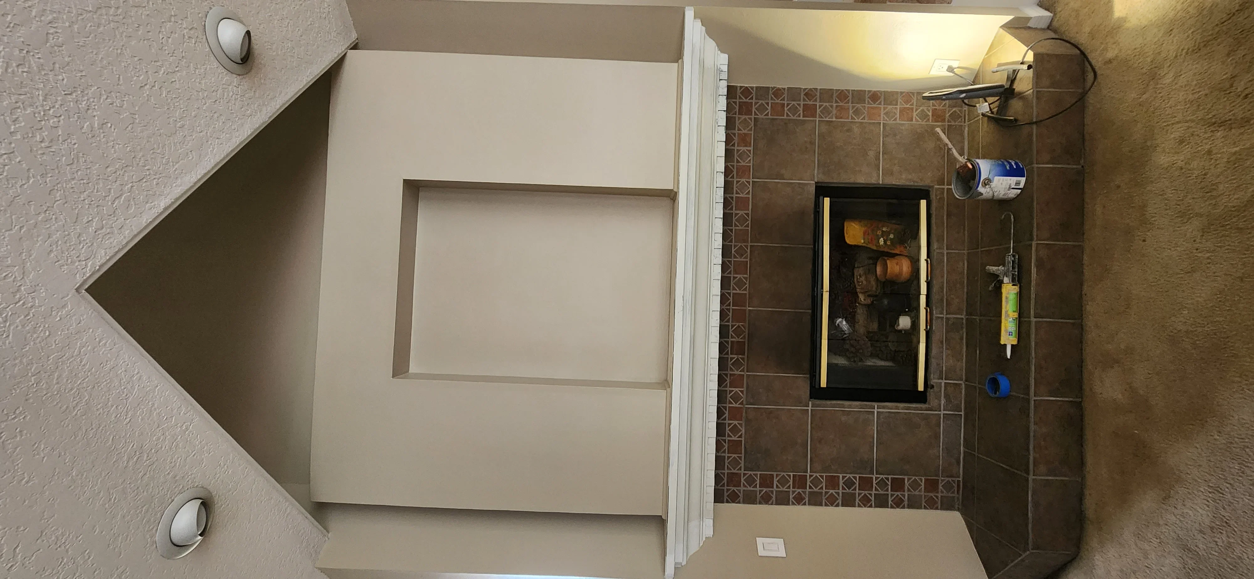 Bathroom with new drywall, brown ceramic tile surround, and recessed medicine cabinet installation